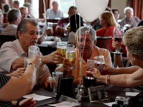 Pointe West Golf Club members raise a toast Saturday, Aug. 16, in Amherstburg. Members of Pointe West were celebrating the club's 25th anniversary. (RICK DAWES/The Windsor Star)