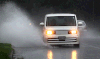 An automobile navigates the water on Dominion Boulevard in Windsor on Aug. 11, 2014. (Dan Janisse / The Windsor Star)