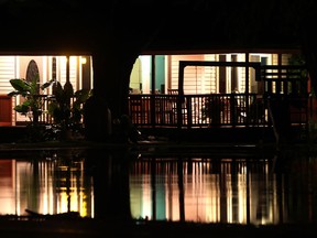 The lights from a house on Highway #20, south of LaSalle are reflected in a flooded front lawn after torrential rain hit the area, Monday, August 11, 2014.   (DAX MELMER/The Windsor Star)