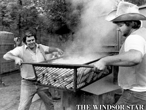 DON'T DROP THAT THING - Wayne Mayor, left, and Jean Marc Roy hoist a basket of steaming corn at Bert Lacasse Park Thursday at the opening of the Tecumseh Corn Festival on Aug. 21, 1980. The festival got off to a wet start Thursday night but the sponsoring Kinsmen Club hopes to serve about 40,000 ears of corn by the end of the weekend. A parade Saturday starts at 11 a.m., to be followed by a firefighters' water barel fight. A horse show and bed race will be held Sunday, the final day of the event. (Bev MacKenzie/Windsor Star)
