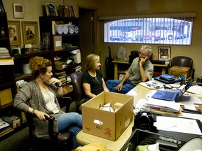 Helena Ventrella, TBQ assistant manager, left, with  auctioneers Janet Lavin and Richard Lavin,  discuss the upcoming auction on August 12, 2014 ( Jay Rankin/The Windsor Star)