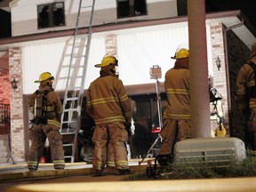 WINDSOR, ONT.: (8/17/14) -- Lasalle fire fighters stand in front of 1518 Rushwood Crst. Sunday, Aug. 17. Crews responded to a working house fire, no one was home and extensive damage was reported. (RICK DAWES/The Windsor Star)