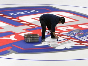 Crews paint the new logos on the ice ahead of the Windsor Spitfires training camp at the WFCU Centre in Windsor in this 2014 file photo. (Tyler Brownbridge/The Windsor Star)