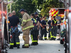 Firefighters, police and paramedics crowd the 500 block of Louis Avenue in response to an incident involving an airborne irritant that turned out to be bear repellent. Aug. 15, 2014. (Dan Janisse / The WIndsor Star)