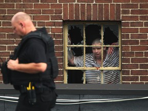 Windsor police work to resolve a standoff with a man armed with a knife barricaded in an apartment at 1616 Ouellette Ave., Sunday, August 31, 2014.  The standoff ended peacefully and the man was taken into custody.  No reported injuries.  (DAX MELMER/The Windsor Star)
