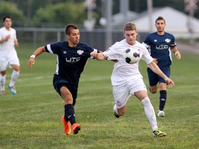 Windsor Star, 11, George Chomakov, and Woodbridge Striker, 7, Nicholas Chiarot fight for the ball at McHugh Soccer Complex in Windsor Saturday, Aug. 23, 2014. The Windsor Stars took on the Woodbridge Strikers. (RICK DAWES/The Windsor Star)