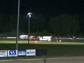 Ambulances on the scene at Canandaigua Motorsports Park on Saturday Aug. 9, 2014 in Canandaigua, N.Y. Authorities are investigating a serious crash that injured one person at a New York dirt track where Tony Stewart was racing on the eve of a NASCAR race. (Logan Messerly/The Associated Press)