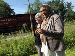 Remy Boulbol meets with Julie Wynne, left, a resident on Memorial Drive near the Canadian Pacific rail line, in Windsor on Friday, August 15, 2014. Residents are complaining about the lack of a fence and maintenance on the CP property. (Tyler Brownbridge/The Windsor Star)