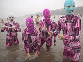Chinese women wear face-kinis as they stand in the water on August 20, 2014 on the Yellow Sea in Qingdao, China. The locally designed mask is worn by many local women to protect them from jellyfish stings, algae and the sun's ultraviolet rays.