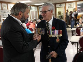 NDP leader Thomas Mulcair, left, meets veteran Larry Costello at the legion in Amherstburg on Thursday, August 21, 2014.               (Tyler Brownbridge/The Windsor Star)