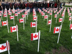 Flags representing Canadian soldiers who died in Afghanistan are shown at the downtown Windsor cenotaph in this May 2014 file photo. (Dan Janisse / The Windsor Star)