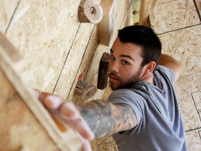 Matthew Westlake, 22, scales The Back Wall behind his home in east Windsor, Saturday, Aug. 23, 2014. Westlake suffers from a rare condition called Klippel-Trenaunay Syndrome and built a wall to climb, an exercise he said that doesn't flair up his condition. (RICK DAWES/The Windsor Star)