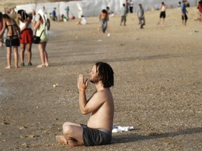 An Israeli youth meditates on the beach in southern Israel on in this April 2010 photo. (DAVID BUIMOVITCH / AFP / Getty Images)