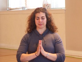 Samantha Menzies will begin teaching prenatal yoga classes next month. Here she demonstrates the seated meditation pose. (JAY RANKIN / The Windsor Star)
