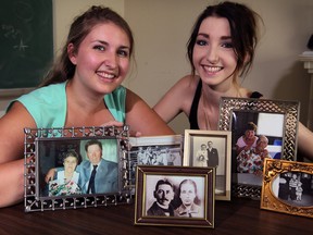 Chelsea Meloche, left, and her sister Kellie Meloche pose with snapshots from their Meloche and Michaelis families Friday September 5, 2014. Chelsea Meloche won the Mike Brede Genealogical Essay competition. (NICK BRANCACCIO/The Windsor Star)