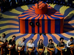 North Koreans enjoy a ride at the Kaeson Youth Amusement Park Wednesday, Sept. 3, 2014 in Pyongyang, North Korea. (AP Photo/Wong Maye-E)