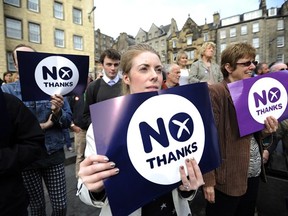 Supporters of the pro-union 'Better Together' campaign hold "No" signs as they listen to Scottish MP Jim Murphy address crowds in Edinburgh on September 8, 2014, ahead of the upcoming Scottish independence referendum. Supporters of the United Kingdom began a fightback to stop Scotland voting for independence in next week's referendum after an opinion poll put the separatists ahead for the first time. AFP PHOTO/ANDY BUCHANANAndy Buchanan/AFP/Getty Images