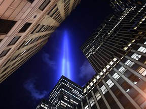 The Tribute in Light illuminates the sky down in the Wall Street area of lower Manhattan in New York on September 10, 2014 on the night before the 13th anniversary of the September 11, 2001 attacks. The tribute, an art installation of the Municipal Art Society, consists of 88 searchlights placed next to the site of the World Trade Center creating two vertical columns of light in remembrance of the 2001 attacks .(TIMOTHY A. CLARY/AFP/Getty Images)