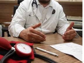 A doctor speaks with a patient about way to reduce high blood pressure, or hypertension, through diet and exercise.
Photograph by: Adam Berry/Getty Images , Postmedia News