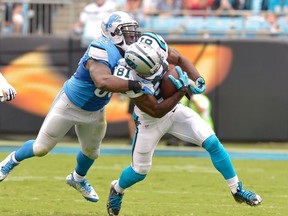 Stephen Tulloch #55 of the Detroit Lions tackles Jason Avant #81 of the Carolina Panthers during their game at Bank of America Stadium on September 14, 2014 in Charlotte, North Carolina. The Panthers won 24-7.  (Photo by Grant Halverson/Getty Images) ORG XMIT: 504234237