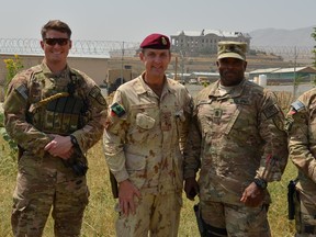 Canadian, Brig.-Gen. Simon Hetherington, deputy commander of the US Army's XVIII Airborne Corps, poses in front of the ruins of the capital's Darul Aman Palace with several American soldiers who are members of what he calls "my team."  The last Canadian general to serve in Afghanistan, Hetherington leads NATO Training missions in Afghanistan. He and six other Canadian officers deployed to Afghanistan will leave the country by the end of the year. HANDOUT: NATO       FOR MATTHEW FISHER (POSTMEDIA NEWS).