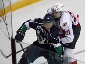 Plymouth's Mathieu Henderson, left, is checked by Windsor's Logan Brown at the WFCU Centre. (DAN JANISSE/The Windsor Star)