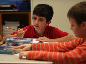 St. Angela Catholic Elementary School Grade 6 students Jacob Lajoie, left, and Seth Grant, work on expanding patterns during math class. EQAO testing results for Windsor-Essex Catholic District School Board were released during press conference at St. Angela School, Wednesday September 17, 2014.  (NICK BRANCACCIO/The Windsor Star)