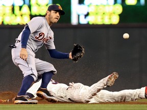 Detroit second baseman Ian Kinsler, top, awaits the throw as Minnesota's Aaron Hicks steals second base in the fourth inning Wednesday in Minneapolis. (AP Photo/Jim Mone)