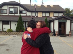 Meadows owner Neda Thomas-Jahn is comforted by friend Darlene Edwards the morning after the fire. (Nick Brancaccio/The Windsor Star)