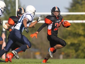 L'Essor's Matei Colgiu, right, is chased by Massey's Nyro Hang, centre, in the third quarter of high school football action Friday. (DAX MELMER/The Windsor Star)