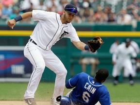 Tigers shortstop Eugenio Suarez, left, tags out Lorenzo Cainof the Royals on his steal attempt during the seventh inning in Detroit. (AP Photo/Carlos Osorio)