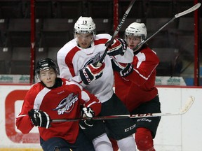 Anton Trublin, from left, Ryan Foss and Nick Gauvin battle for the puck during a scrimmage at Spitfires training camp at the WFCU Centre. (Tyler Brownbridge/The Windsor Star)