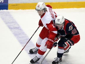 Windsor's Ryan Moore, right, checks Jordan Karterud of the Soo Greyhounds at the WFCU Centre. (TYLER BROWNBRIDGE/The Windsor Star)