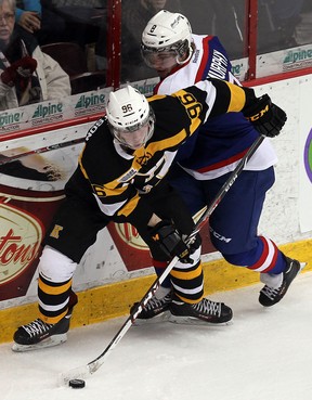 Windsor's Trevor Murphy, right, checks Kingston's Spencer Watson at the WFCU Centre. (TYLER BROWNBRIDGE/The Windsor Star)