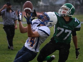 Herman's Aaron Butler, right, battles St. Anne's Alex Bornais during WECSSAA boys football action. (DAX MELMER/The Windsor Star)