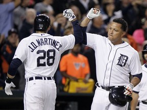 J.D. Martinez, left, celebrates his two-run home run against the Cleveland Indians with Miguel Cabrera at Comerica Park on September 12, 2014, in Detroit, Michigan. (Photo by Duane Burleson/Getty Images)