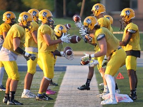 University of Windsor football players do a ball-handling drill during practice at Alumni Field. (DAN JANISSE/The Windsor Star)