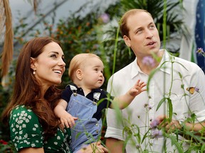 A file picture taken on Wednesday July 2, 2014, to mark Britain's Prince George's first birthday, shows Prince William (R) and Catherine, Duchess of Cambridge (L) with Prince George during a visit to the Sensational Butterflies exhibition at the Natural History Museum in London. (AFP PHOTO / JOHN STILLWELL)