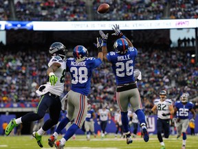 Giants safety Antrel Rolle, right, makes an interception against the Seattle Seahawks. In the background is LaSalle's Luke Willson of the Seahawks. (Photo by Ron Antonelli/Getty Images)