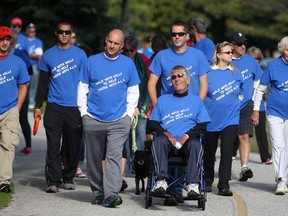 Friends and family walk with Bill Maden, centre, who was diagnosed with ALS in March of 2012, during the ALS WIndsor Walk on the Ganatchio Trail, Sunday, Sept. 14, 2014.   (DAX MELMER/The Windsor Star)