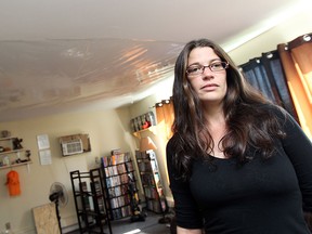 Chantal Janisse shows off the plastic sheeting which was installed to keep the water out of her unit at an apartment building on Meadowbrook Lane in Windsor on Tuesday, September 23, 2014. Residents of the buildings are forming a tenant association to protest the conditions of the buildings.                     (TYLER BROWNBRIDGE/The Windsor Star)