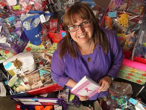 Maureen Parent is shown with a bunch of gifts she has collected for an upcoming fundraising event she is organizing. The 10-year breast cancer survivor has raised $100,000 over the years and hopes to reach $1 million for breast cancer research.  (DAN JANISSE/The Windsor Star)