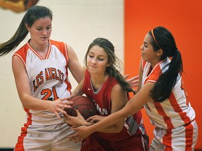 Brennan's Kira Hadland is double teamed by L'Essor's Lauren Golding (L) and Valeria Cabrera during their game Tuesday, Sept. 6, 2014, at L'Essor.  (DAN JANISSE/The Windsor Star)
