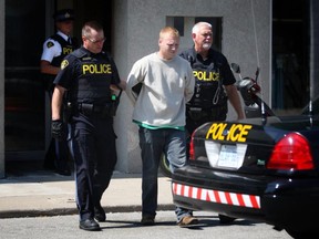 Officers with the Ontario Provincial Police in Leamington arrest a suspect wanted in connection with a shooting on Friday, Sept. 5, 2014. (DAX MELMER/The Windsor Star)
