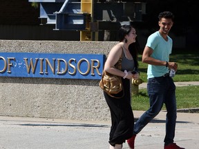 Students walk by the University of Windsor sign on campus, Sept. 5, 2014. (Tyler Brownbridge / The Windsor Star)