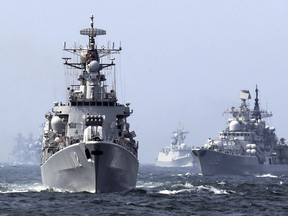 In this May 24, 2014 photo, China's Harbin (112) guided missile destroyer, left, and DDG-139 Ningbo Sovremenny class Type-956EM destroyer, right, take part in a week-long China-Russia "Joint Sea-2014" navy exercise at the East China Sea off Shanghai, China. Several Asian nations are arming up, their wary eyes fixed squarely on one country: a resurgent China thats boldly asserting its territorial claims all along the East Asian coast. The scramble to spend more defense dollars comes amid spats with China over contested reefs and waters. Other Asian countries such as India and South Korea are quickly modernizing their forces, although their disputes with China have stayed largely at the diplomatic level. (AP Photo) CHINA OUT ORG XMIT: XAW802