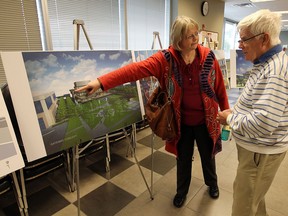 Sarah Jarvis and Bob MacIntosh look over proposals for the new city hall and vote on their favourite during an open house at city hall in Windsor on Tuesday, September 16, 2014.                    (TYLER BROWNBRIDGE/The Windsor Star)