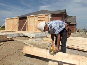 George Loewen, from Loewen Construction, works on a home being built on Inverness Ave., Friday, Sept. 5, 2014.  (DAX MELMER/The Windsor Star)