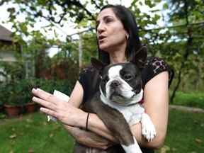 WINDSOR, ONT.:SEPTEMBER 20, 2014 -- Katia Paparone pictured with her dog, Lola, a Boston terrier,  in her backyard, Saturday, Sept. 20, 2014, is petitioning the city to add temperature limits to its animal bylaw. (DAX MELMER/The Windsor Star)