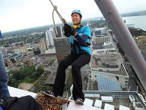 A nervous Lana Bezjak leans off the edge to start her trip down the side of Caesars Windsor as she takes part in the Easter Seals Drop Zone in Windsor on Monday, September 15, 2014.                    (TYLER BROWNBRIDGE/The Windsor Star)